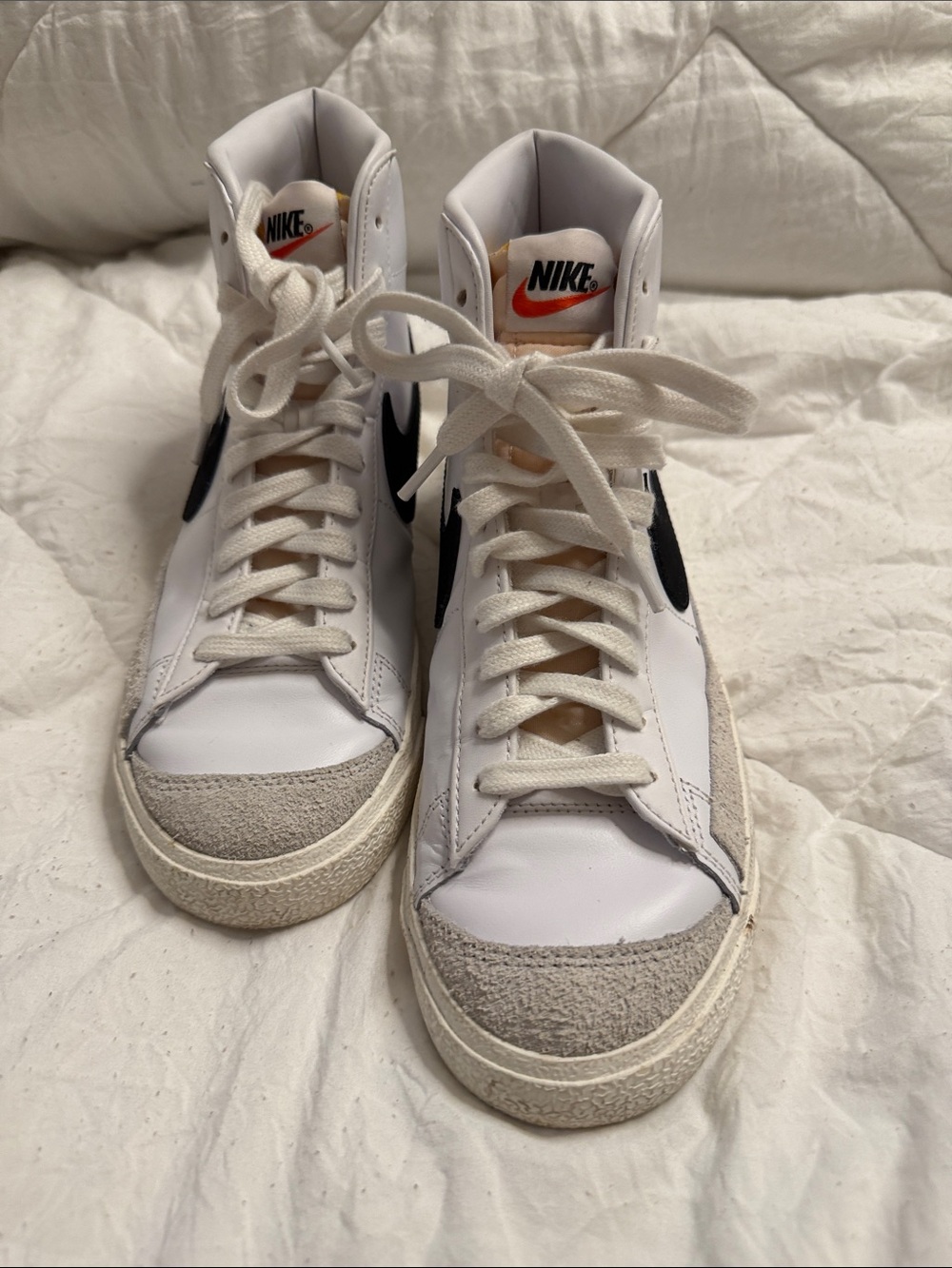 Nike White High-Top Sneakers with Black Swoosh and Orange Tongue